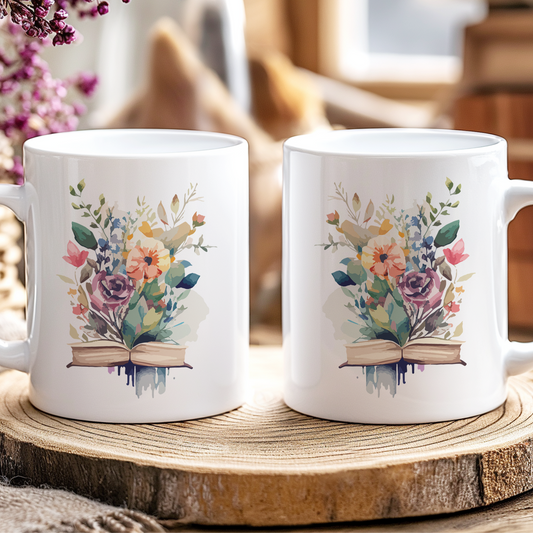 Two white mugs with floral designs on a wooden coaster, surrounded by flowers and jars.