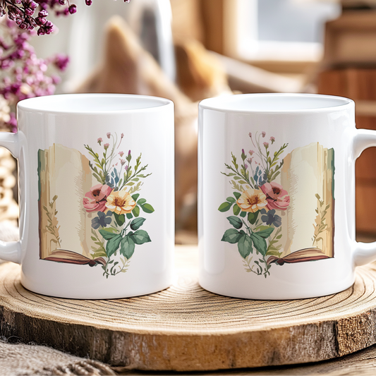 Two white mugs with floral and book design on a wooden coaster.