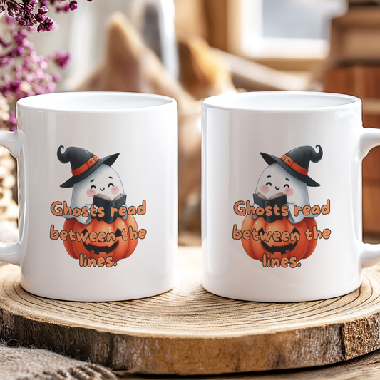 Two white mugs with Halloween-themed design featuring ghosts and pumpkins on a wooden coaster.