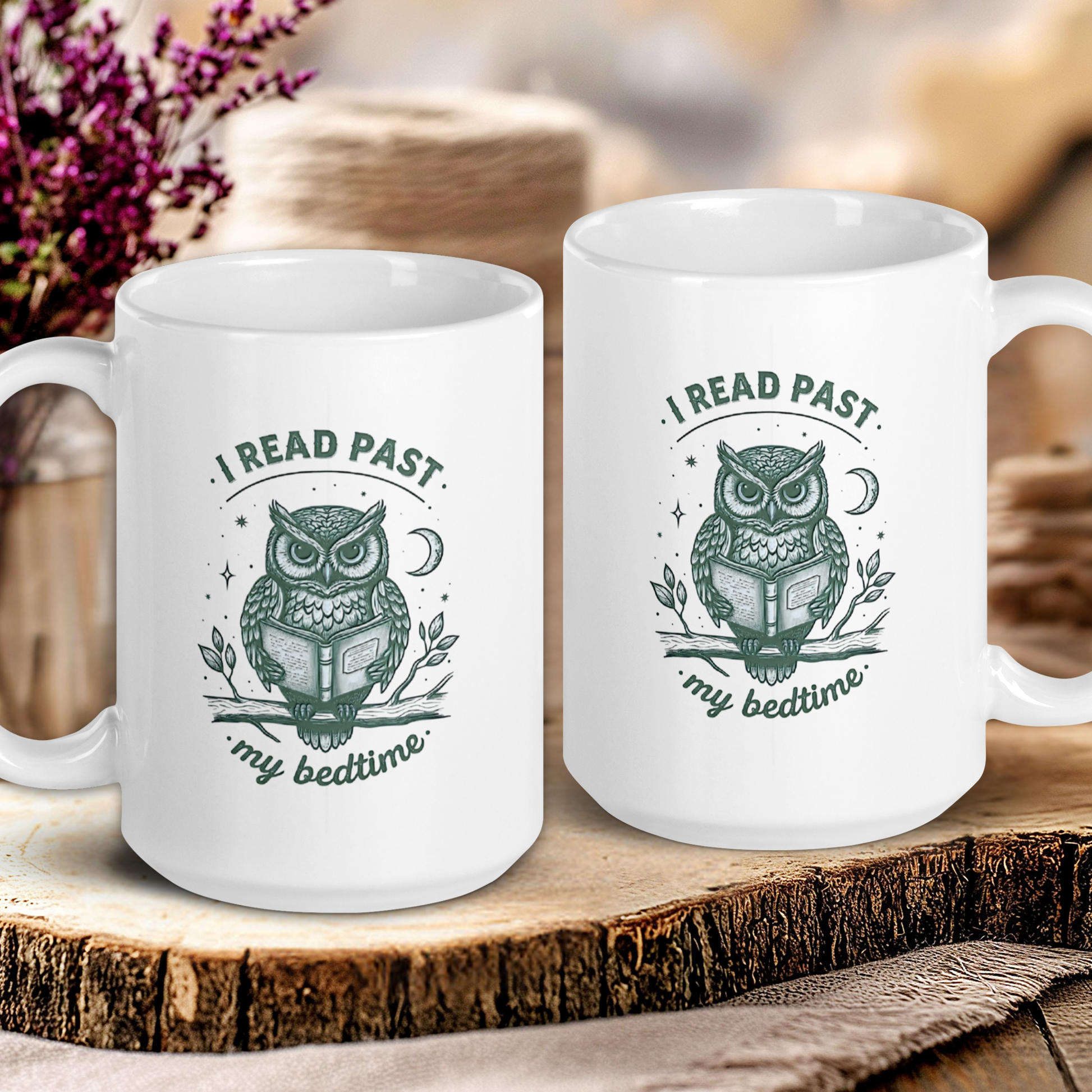 Two white mugs with owl designs and text on a wooden surface.