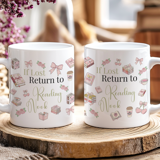 Two white mugs with decorative text on a wooden coaster, surrounded by flowers and books.