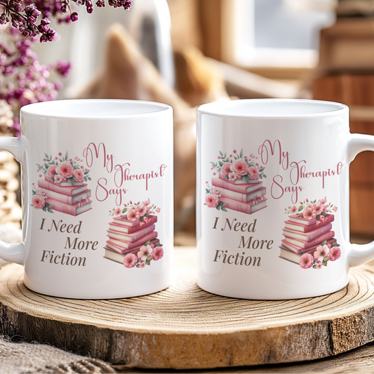 Two white mugs with floral designs and text on a wooden coaster.