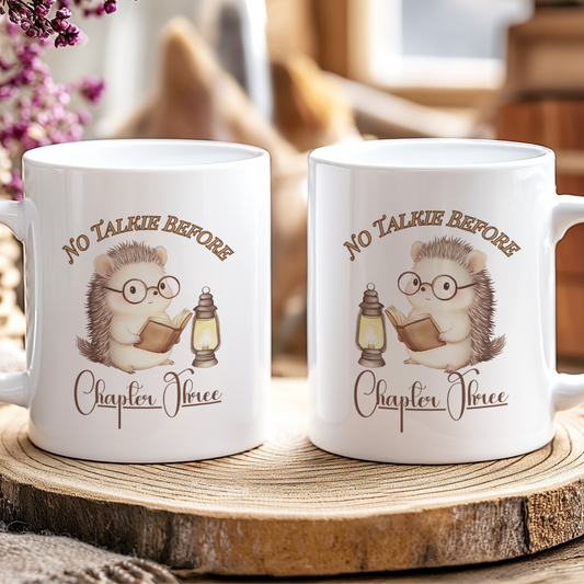 Two mugs with hedgehog illustrations and text on a wooden coaster.