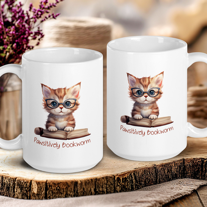 Two mugs with a cat illustration and text on a wooden surface.