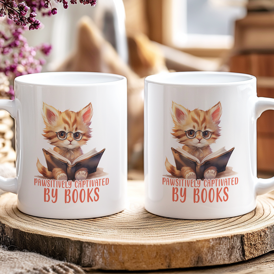 Two mugs with a cat illustration and text 'Pawsitively Captivated by Books' on a wooden coaster.
