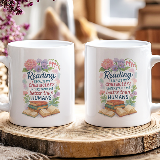 Two white mugs with a colorful design on a wooden coaster.