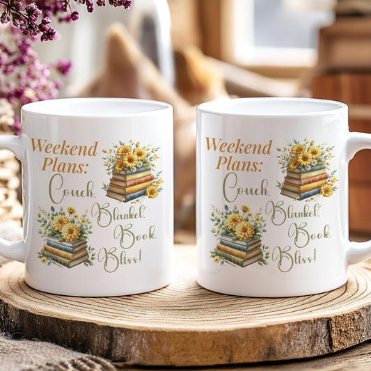 Two white mugs with decorative text and images on a wooden surface.