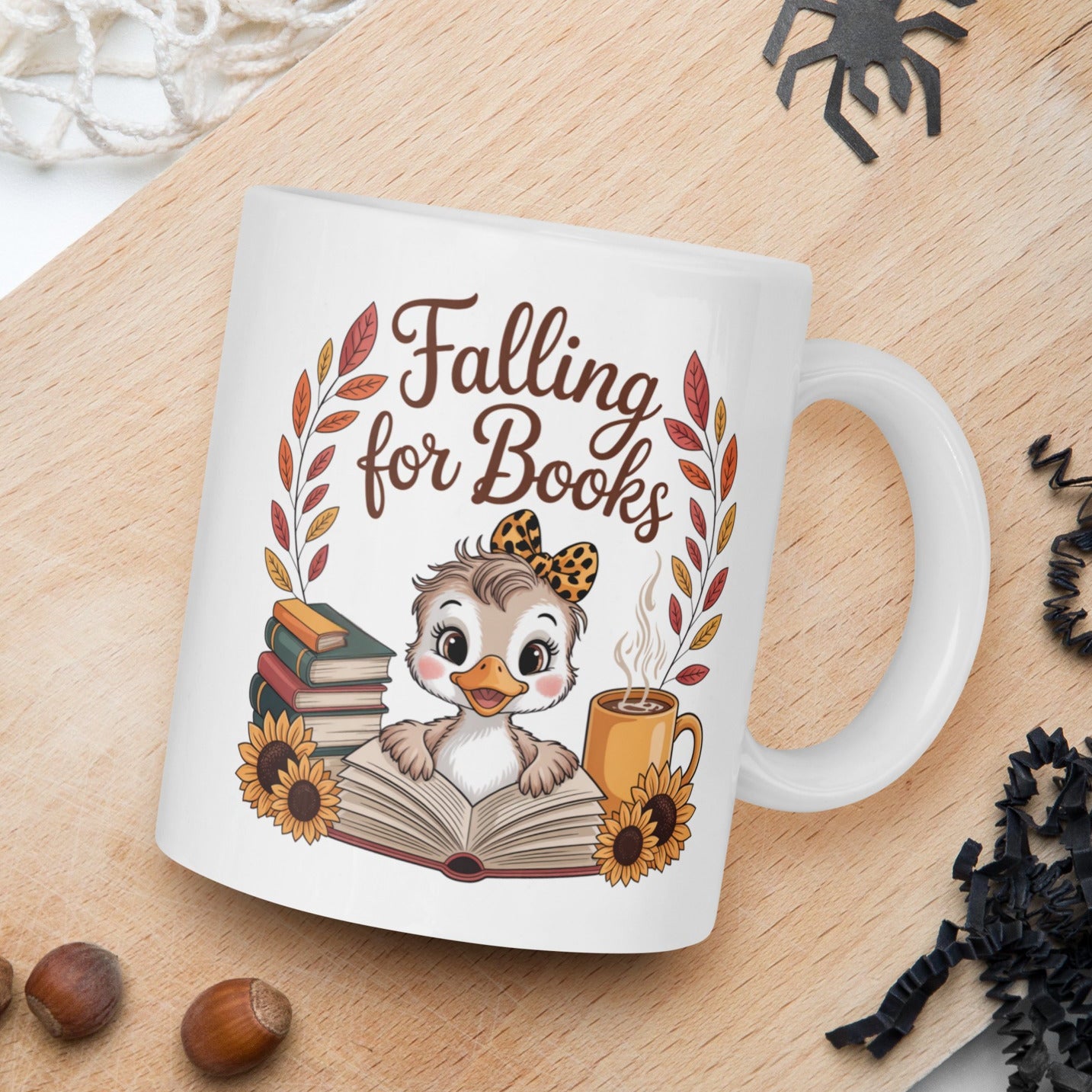 Mug with 'Falling for Books' design featuring a duck and books on a wooden board with autumn elements.