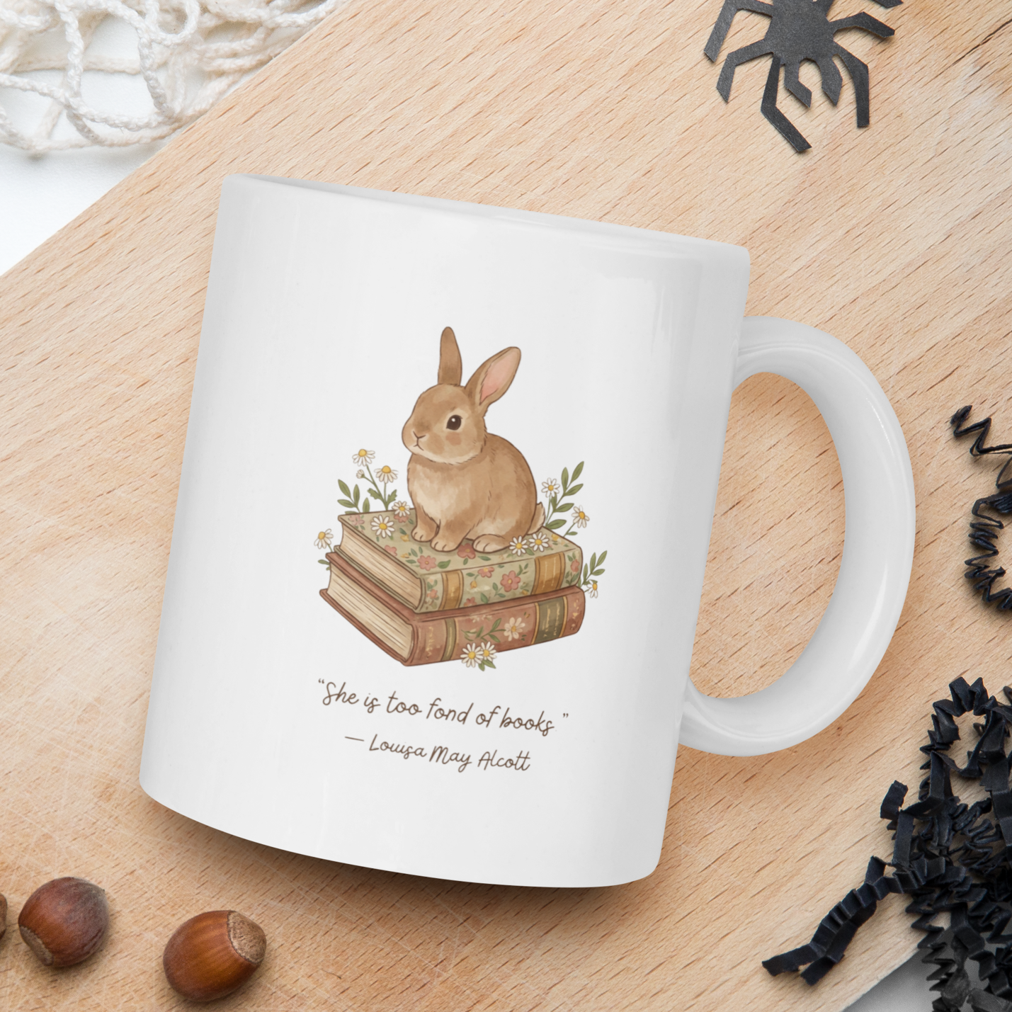 White mug with rabbit illustration on a wooden board with natural elements