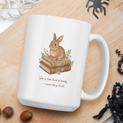 White mug with rabbit illustration and text on a wooden board with natural elements