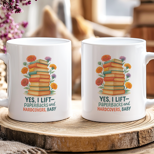 Two mugs with a book-themed design on a wooden coaster.